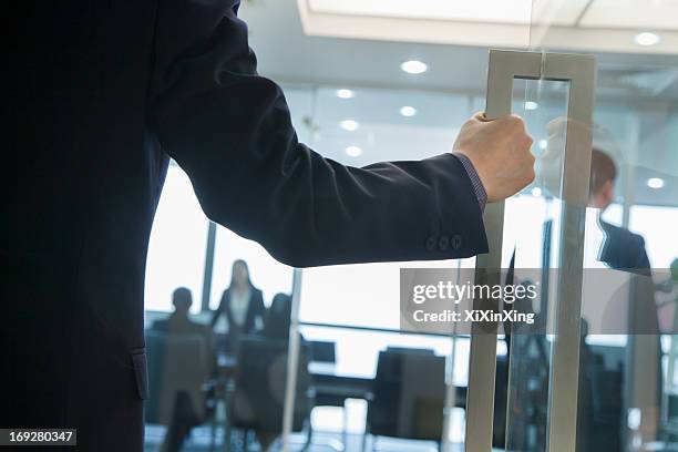 businessman entering an office - entering photos et images de collection