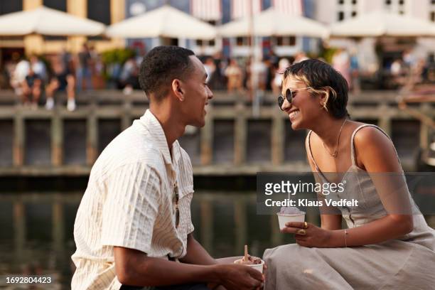 smiling girlfriend and boyfriend with ice cream cups - zealand denmark stock pictures, royalty-free photos & images