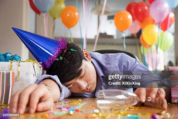 male asleep after party at office - hangover work stock pictures, royalty-free photos & images