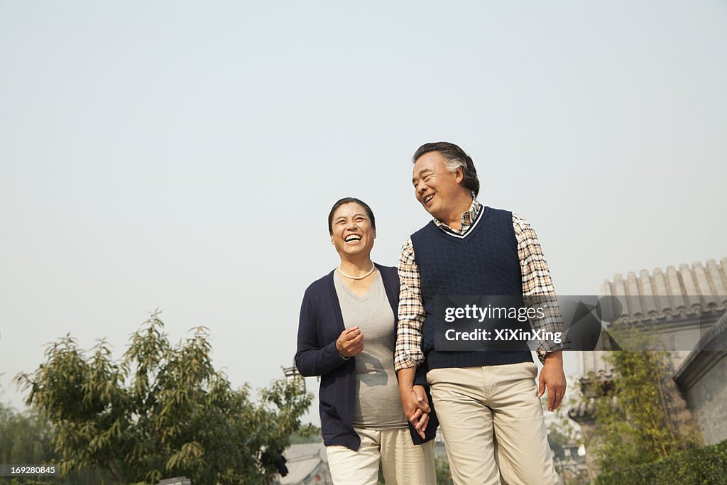 Senior couple going for a stroll in Beijing, holding hands