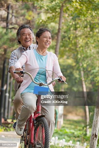 older couple riding tandem bicycle, beijing - bicycle tandem stock pictures, royalty-free photos & images