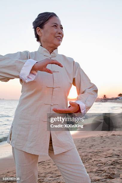 mature women practicing taijiquan, china - woman and tai chi stock pictures, royalty-free photos & images