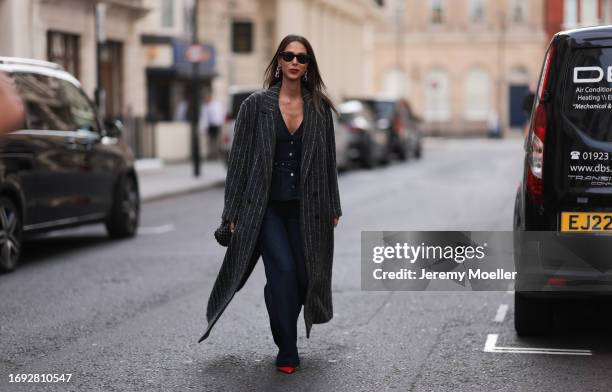 Isabella Charlotta Poppius seen outside Molly Goddard show wearing black Rayban sunnies, silver chunky earrings, denim top and macthing pants in dark...