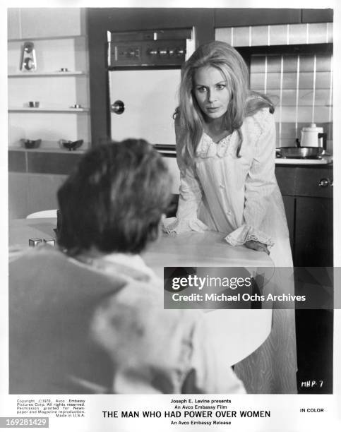 Penelope Horner leaning against counter in a scene from the film 'The Man Who Had Power Over Women', 1970.