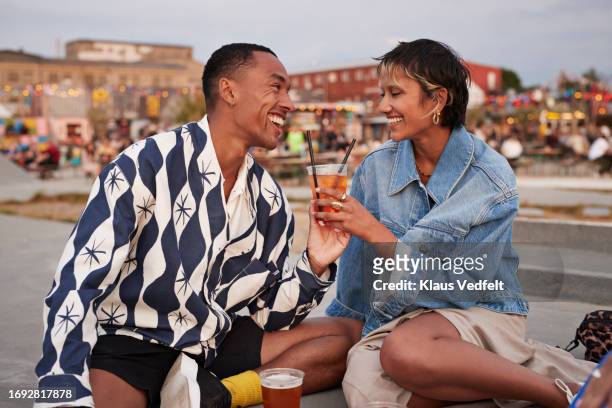 happy heterosexual couple holding drink glass on promenade - danemark stock pictures, royalty-free photos & images