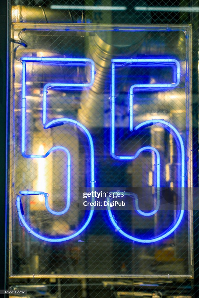 Neon Sign 55 in Store Window at Night
