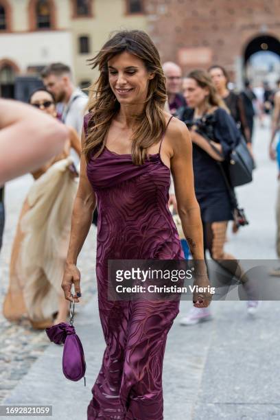 Italian actress Elisabetta Canalis wears burgundy dress outside Alberta Ferretti during the Milan Fashion Week - Womenswear Spring/Summer 2024 on...