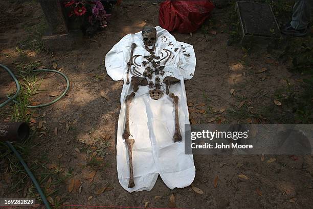 An unidentified immigrant's bones are reassembled after the remains were exhumed from a gravesite on May 22, 2013 in Falfurrias, Brooks County,...