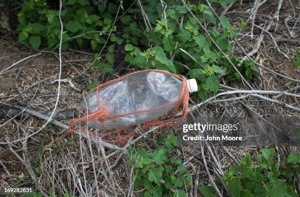 An empty water bottle lies next to where the human bones of a suspected undocumented immigrant were found on a ranch by the U.S. Border Patrol on May...