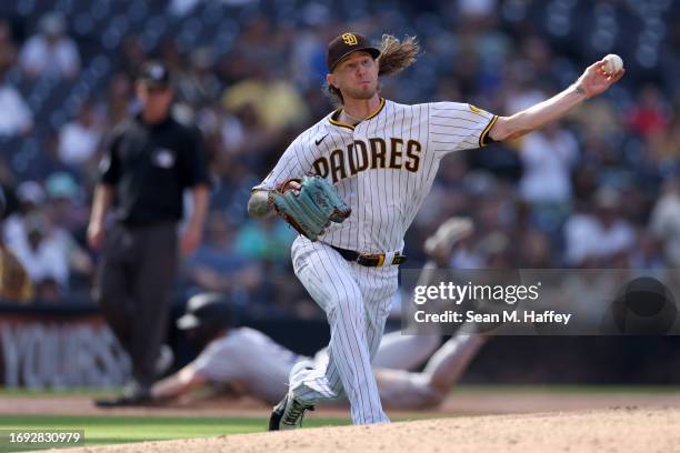 Josh Hader of the San Diego Padres throws out Charlie Blackmon of the Colorado Rockies after he grounded to the pitcher during the ninth inning of a...