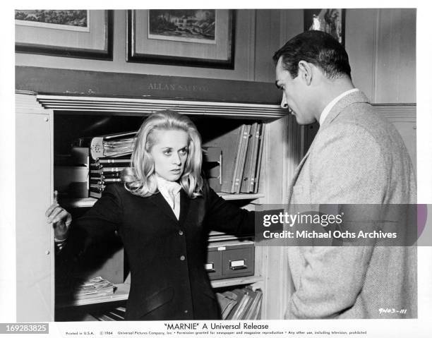 Tippi Hedren is caught by Sean Connery while trying to rifle his safe in a scene from the film 'Marnie', 1964.