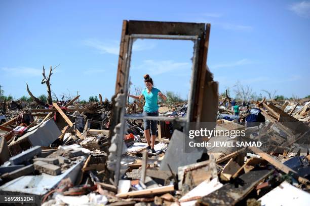 Woman searches for salvageable belongings at a tornado-devastated home on May 22, 2013 in Moore, Oklahoma. As rescue efforts in Oklahoma wound down,...