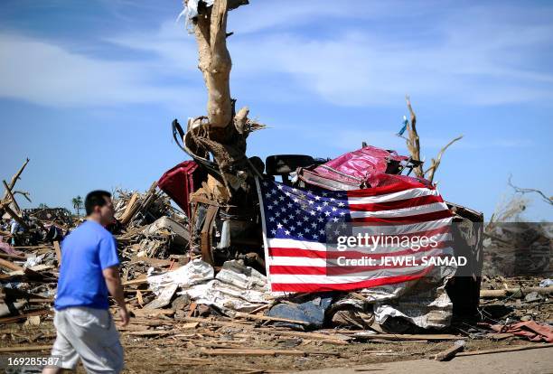 Man stands in front of his tornado devastated home on May 22, 2013 in Moore, Oklahoma. As rescue efforts in Oklahoma wound down, residents turned to...