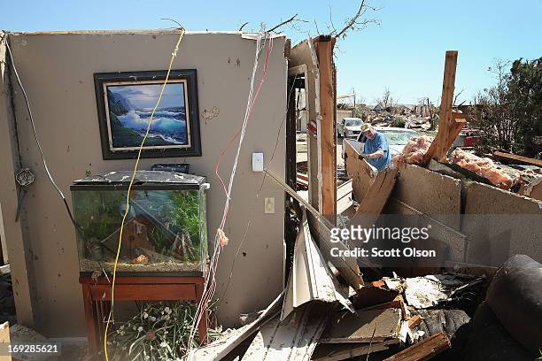Fish still swim in a tank sitting in what was once the livingroom of Don Jackson's home before it was destroyed by a tornado that ripped through the...
