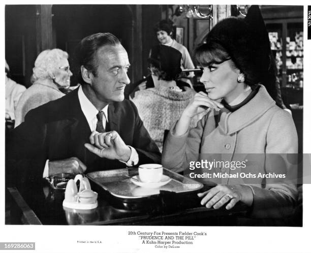 David Niven and Irina Demick have tea in a scene from the film 'Prudence And The Pill', 1968.