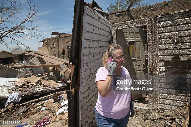 Wayneta Canary helps remove drebris and recover items from her mother's home after it was destroyed by a tornado that ripped through the area on May...