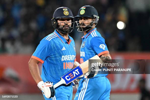 India's captain Rohit Sharma and his teammate Virat Kohli run between the wickets during the third and final one-day international cricket match...