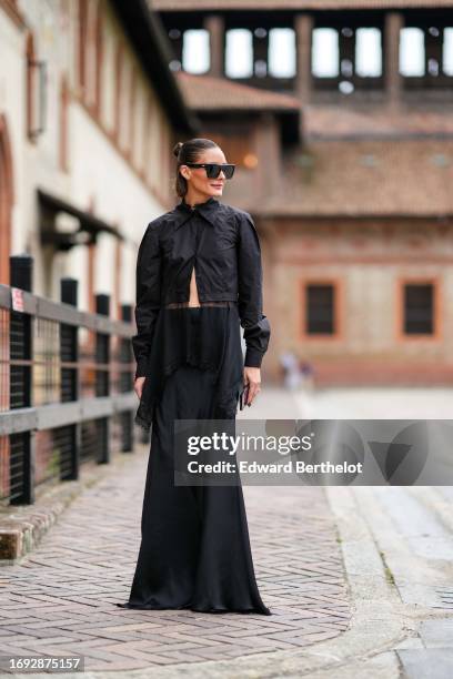 Olivia Palermo wears sunglasses, a black shirt, a black long dress with tulle / mesh, outside Alberta Ferretti, during the Milan Fashion Week -...