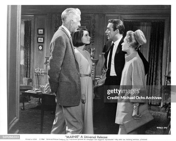 Sean Connery introduces his bride to be Tippi Hedren to his father Alan Napier and his sister-in-law Diane Baker in a scene from the film 'Marnie',...