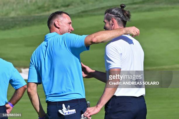 Former Ukrainian footballer Andriy Shevchenko and Former Welsh footballer Gareth Bale embrace after the All-Star match played ahead of the 44th Ryder...