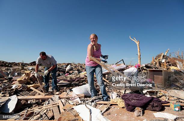 Thomas Trowbridge along with wife Kelcy and her mother Cindy Moore salvage items from Trowbridge's house destroyed by the tornado May 22, 2013 in...
