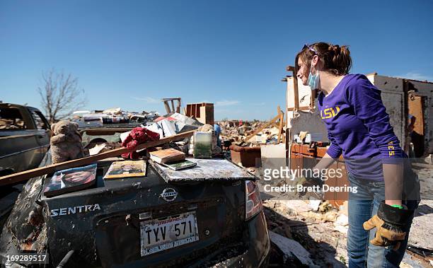 Tara McDonald shows some items salvaged from her house after it was destroyed May 22, 2013 in Moore, Oklahoma. The two-mile-wide Category 5 tornado...