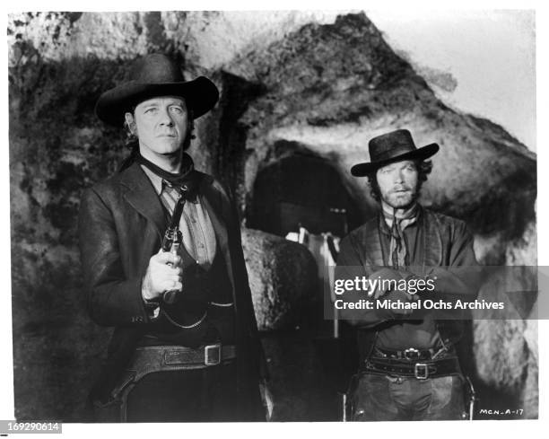 Richard Crenna and Stephen Boyd confront a group of bandits in a scene from the film 'The Man Called Noon', 1973.