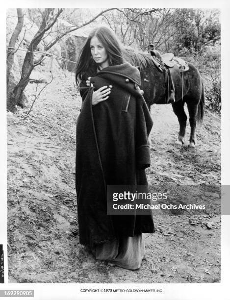 Sarah Miles pulling her coat around her in a scene from the film 'The Man Who Loved Cat Dancing', 1973.