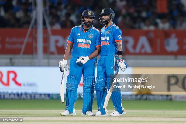 Rohit Sharma of India and Virat Kohli of India interact during game three of the One Day International series between India and Australia at...