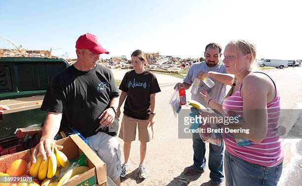 Travis French and his wife Amy of the Capitol Hill Baptist Church hand out fresh fruit, water and hygiene packs to Thomas and Kelcy Trowbridge May...