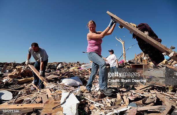 Thomas Trowbridge along with wife Kelcy and her mother Cindy Moore salvage items from Trowbridge's house destroyed by the tornado May 22, 2013 in...