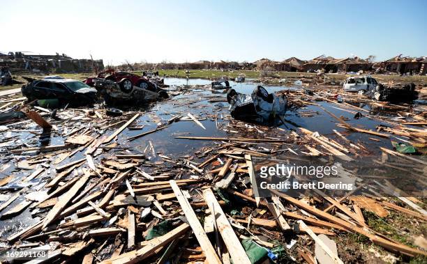 Cars and debris fill what had been a wetlands destroyed by the tornado at Briarwood Elementary School May 22, 2013 in Moore, Oklahoma. The...