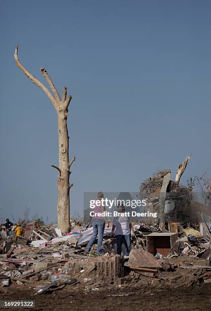 Kelcy Trowbridge and her mother Cindy Moore stand in the rubble of Trowbridge's house May 22, 2013 in Moore, Oklahoma. The two-mile-wide Category 5...