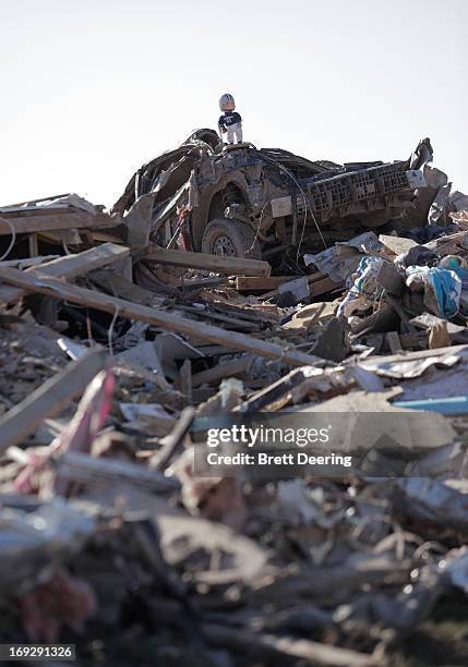 Dallas Cowboys doll sits on top of a car in the rubble of the tornado May 22, 2013 in Moore, Oklahoma. The two-mile-wide Category 5 tornado touched...