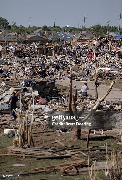 People begin the process of salvaging belongings after the tornado May 22, 2013 in Moore, Oklahoma. The two-mile-wide Category 5 tornado touched down...