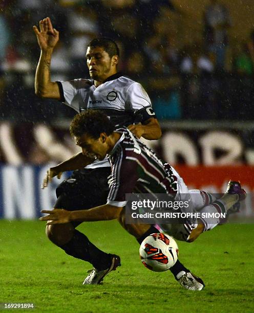 Brazilian Fluminense's Nem Wellington vies for the ball with Paraguayan Olimpia's Richard Ortiz during their Copa Libertadores football match at the...