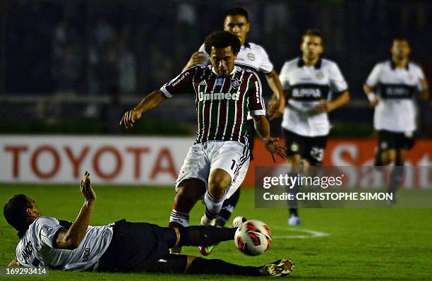 Brazilian Fluminense's Nem Wellington vies for the ball with Paraguayan Olimpia's Julio Cesar Manzur during their Copa Libertadores football match at...