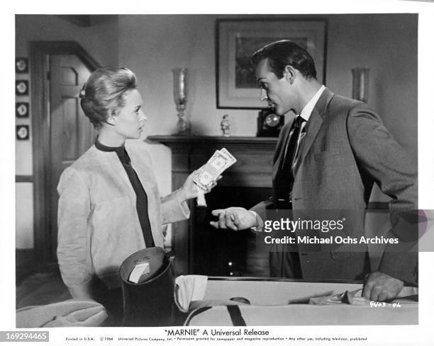 Sean Connery persuades Tippi Hedren to return the money she had taken from the company safe in a scene from the film 'Marnie', 1964.