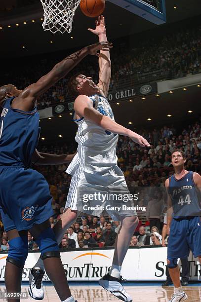 Mike Miller of the Orlando Magic puts up a shot during the NBA game against the Washington Wizards at TD Waterhouse Centre on December 6, 2002 in...