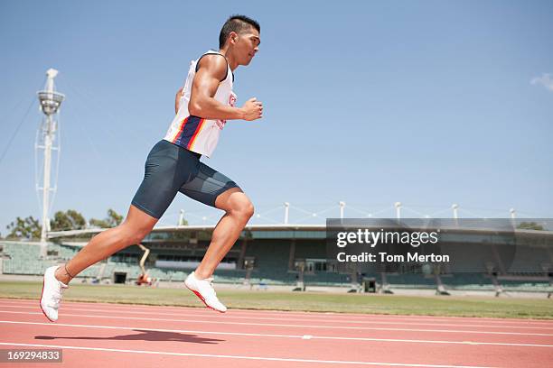 runner on track - males running stock pictures, royalty-free photos & images