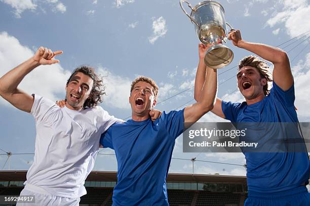 soccer players cheering with trophy - trophy day 3 stock pictures, royalty-free photos & images