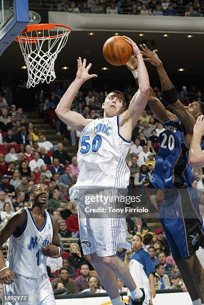 Mike Miller of the Orlando Magic battles for the rebound against Larry Hughes of the Washington Wizards during the NBA game at TD Waterhouse Centre...