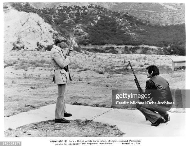 Jan-Michael Vincent And Charles Bronson with guns in a scene from the film 'The Mechanic', 1972.