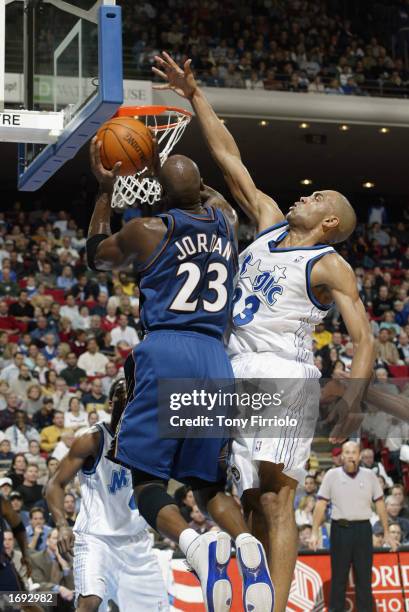 Michael Jordan of the Washington Wizards goes up for the shot against Grant Hill of the Orlando Magic during the NBA game at TD Waterhouse Centre on...