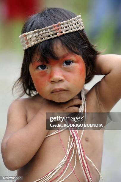 An Ecuadorean Waorani boy poses for a picture at the Yasuni National Park, at the Ecuadorean Amazon forest, on August 21, 2010. AFP PHOTO / RODRIGO...