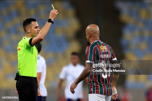 Referee shows a yellow card toFelipe Melo of Fluminense during the match between Fluminense and Cruzeiro as part of Brasileirao 2023 at Maracana...
