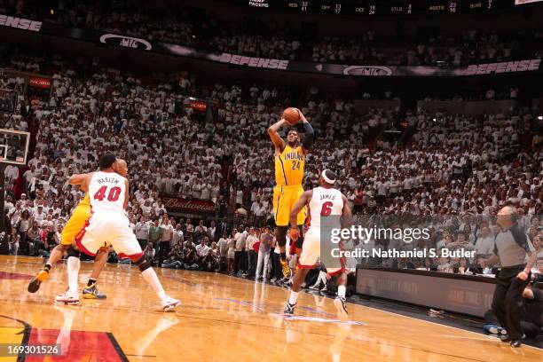 Paul George of the Indiana Pacers hits a three against LeBron James of the Miami Heat to tie the game and force overtime in Game One of the Eastern...