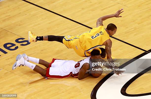 Norris Cole of the Miami Heat dives for a loose ball against George Hill of the Indiana Pacers in overtime during Game One of the Eastern Conference...