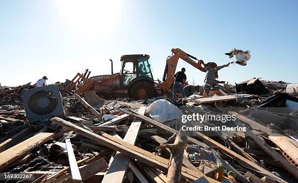 Member of the 552nd Air Control Wing at Tinker Air Force Base helps a resident salvage items after the tornado May 22, 2013 in Moore, Oklahoma. The...