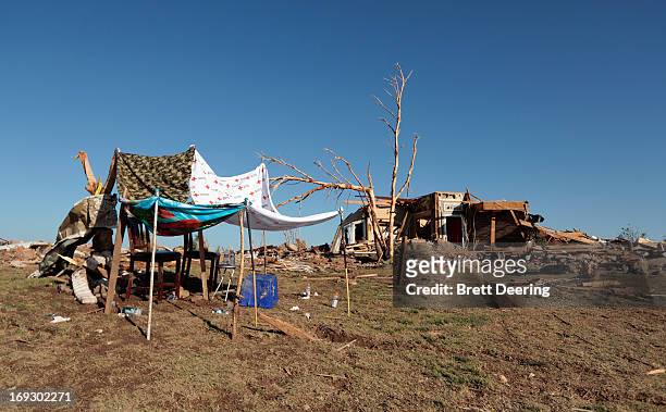 Makeshift shelter is setup next to a home destroyed by the tornado May 22, 2013 in Moore, Oklahoma. The two-mile-wide Category 5 tornado touched down...